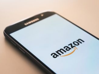 Smart phone with Amazon logo on a white screen