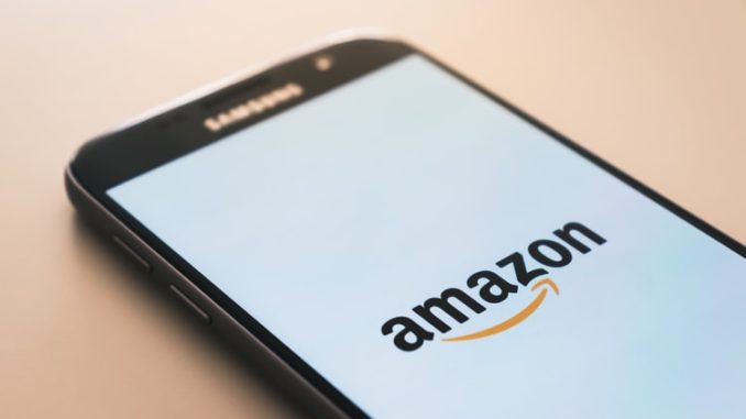 Smart phone with Amazon logo on a white screen