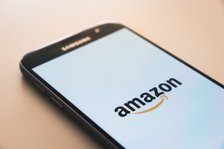 Smart phone with Amazon logo on a white screen